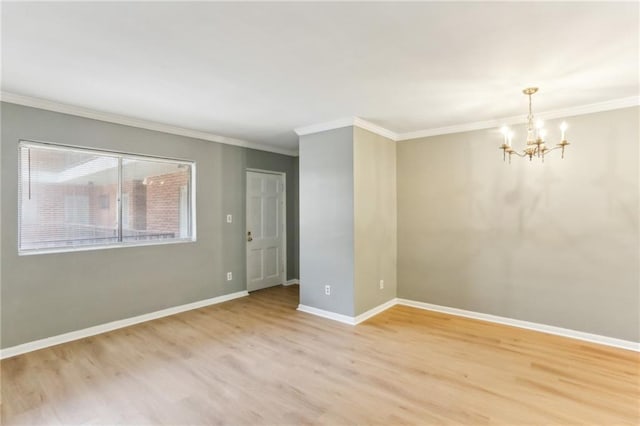 91 Rumson Rd NE Unit B25, Atlanta, GA 30305 - spare room featuring a chandelier, ornamental molding, light wood-style floors, and baseboards