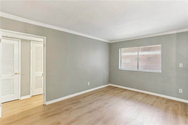 91 Rumson Rd NE Unit B25, Atlanta, GA 30305 - unfurnished bedroom featuring ornamental molding, light wood-style flooring, and baseboards
