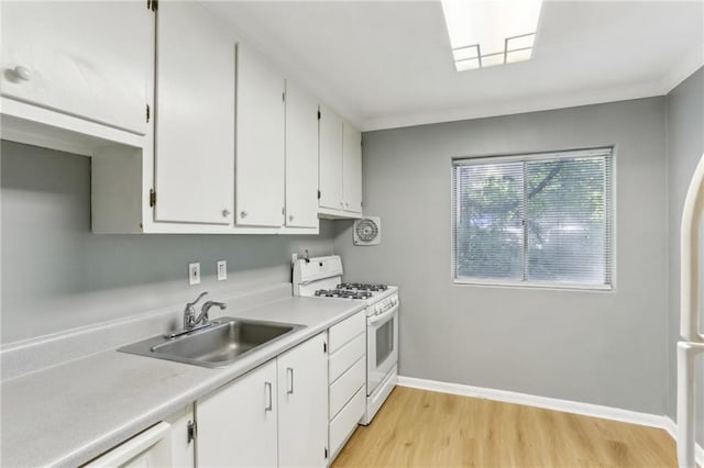 91 Rumson Rd NE Unit B25, Atlanta, GA 30305 - kitchen featuring white range with gas stovetop, a sink, white cabinets, light wood-type flooring, and light countertops