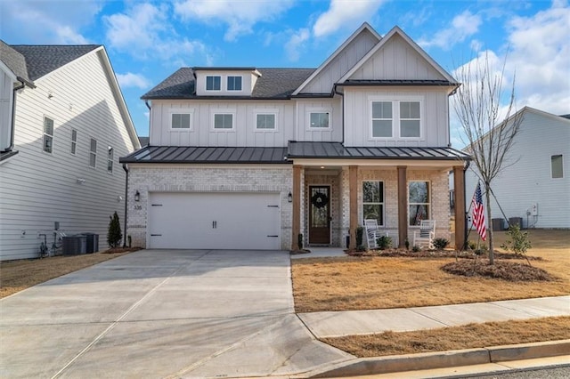 modern farmhouse style home featuring covered porch, a standing seam roof, board and batten siding, and brick siding