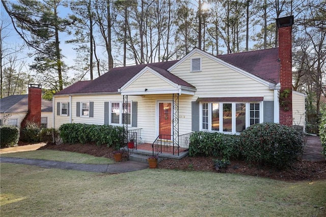 view of front of property with a chimney and a front yard