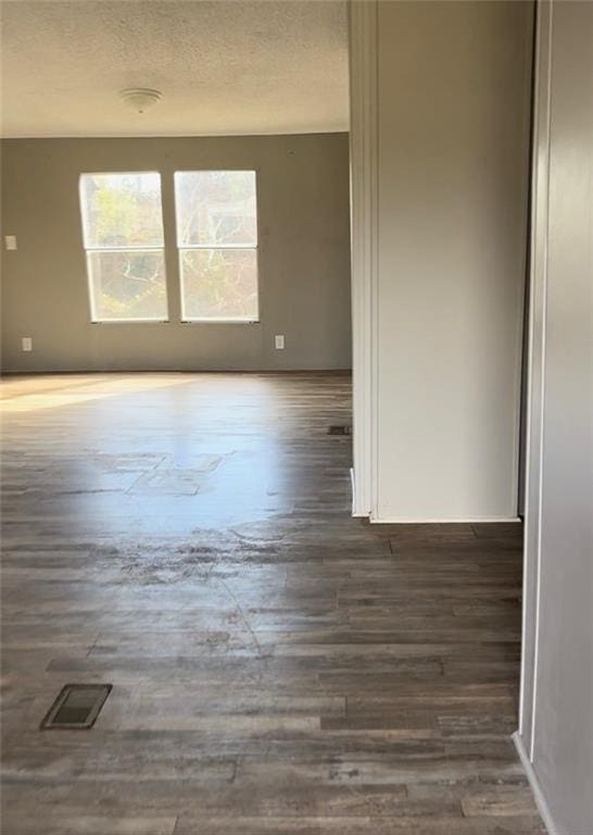 empty room featuring dark wood-type flooring