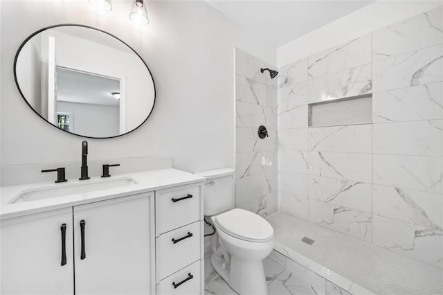 full bath with marble finish floors, a tile shower, vanity, and toilet