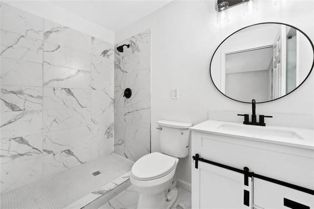 full bath with marble look tile flooring, a tile shower, toilet, vanity, and baseboards