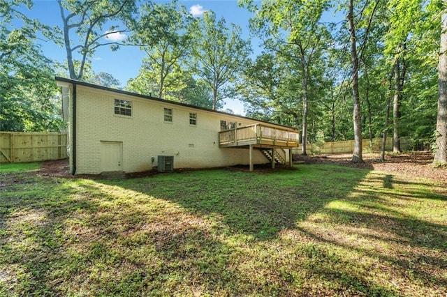 back of property with stairs, a deck, brick siding, and central AC unit