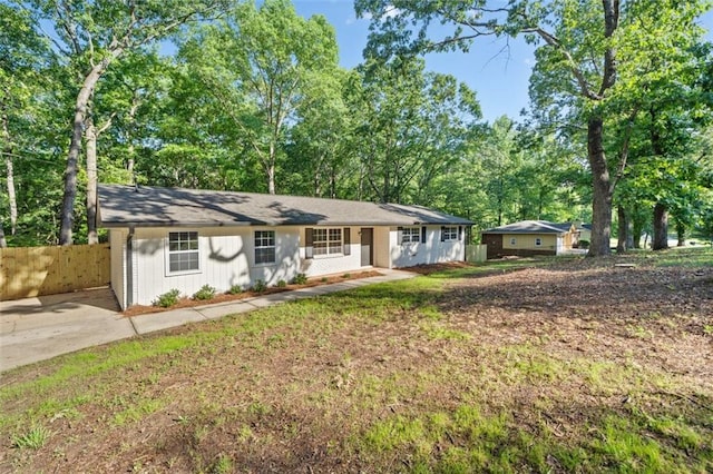 ranch-style home with fence