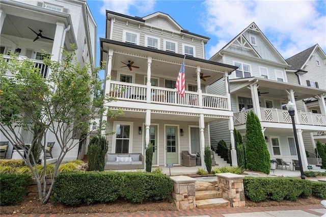 view of front of house featuring a balcony, ceiling fan, and a patio area