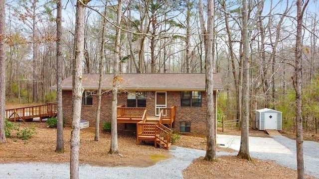 view of front of home featuring a storage unit and a deck