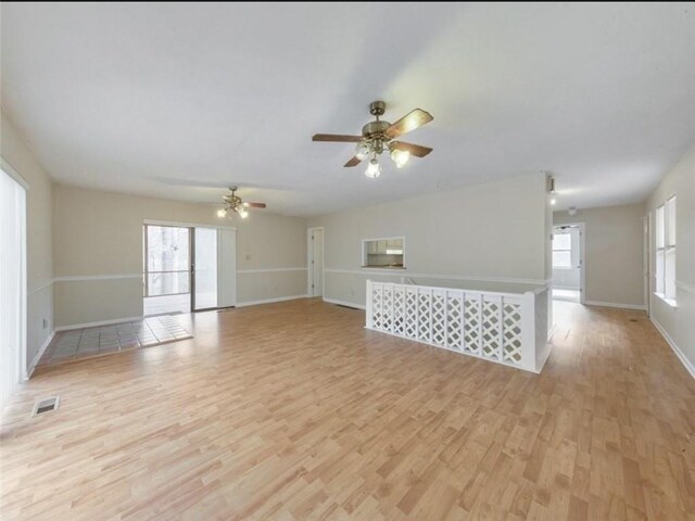 unfurnished living room featuring ceiling fan and light hardwood / wood-style flooring