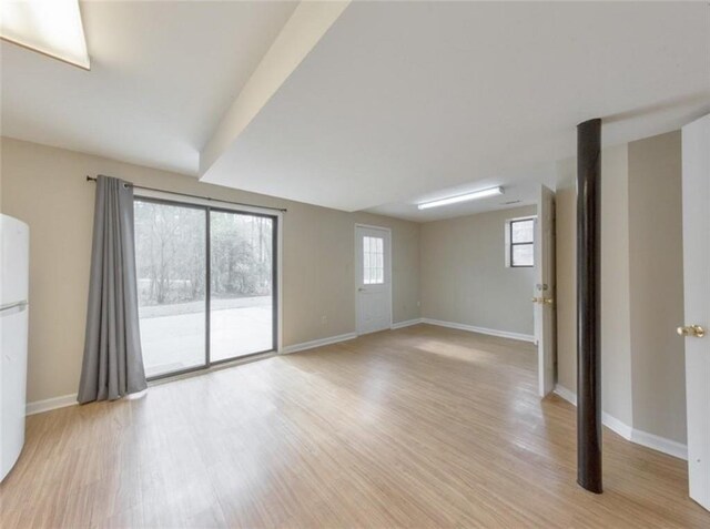 interior space with light hardwood / wood-style floors and a wealth of natural light