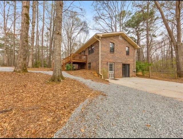 view of property exterior with a deck and a garage