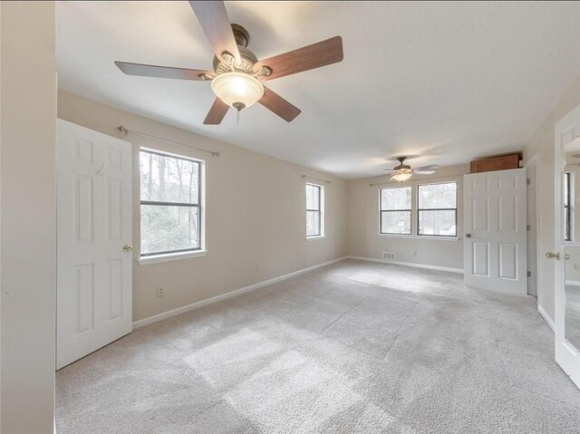 carpeted empty room with ceiling fan