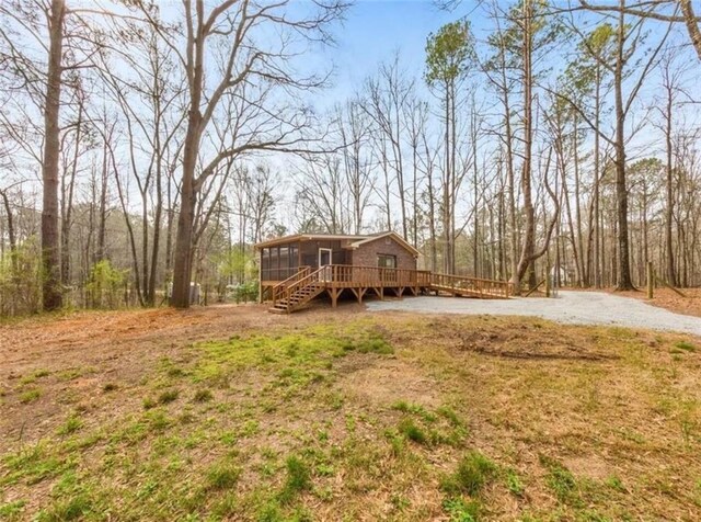 view of yard with a sunroom and a deck