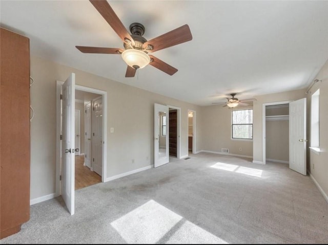 unfurnished bedroom with light carpet and ceiling fan