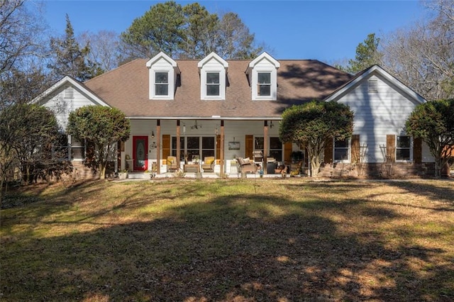 rear view of property featuring a patio and a lawn