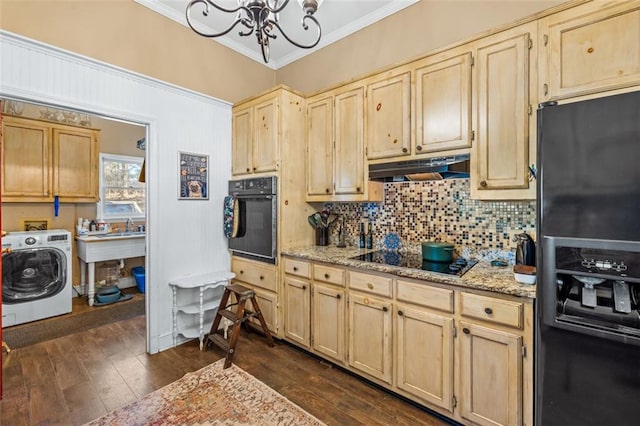 kitchen featuring tasteful backsplash, washer / clothes dryer, ornamental molding, under cabinet range hood, and black appliances