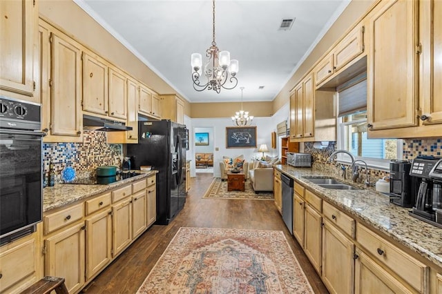 kitchen featuring a chandelier, light brown cabinetry, and black appliances