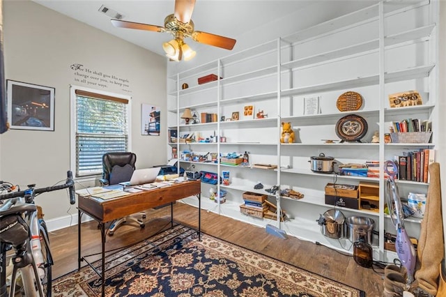 office with visible vents, ceiling fan, baseboards, and wood finished floors