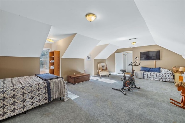 bedroom featuring vaulted ceiling, carpet floors, and visible vents