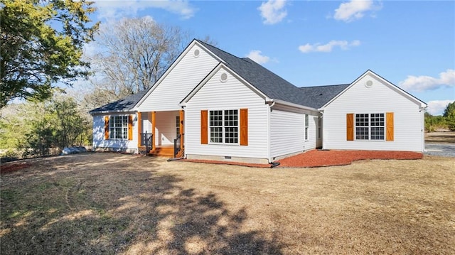 view of front facade with covered porch, a yard, and crawl space