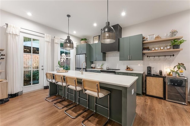 kitchen featuring pendant lighting, a kitchen bar, light wood-type flooring, and sink