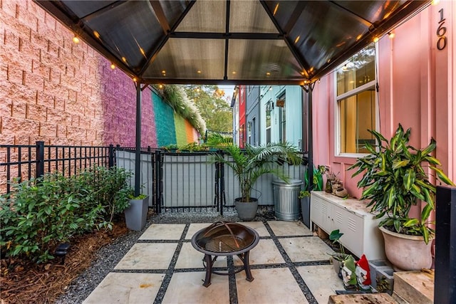 view of patio / terrace with a gazebo and a fire pit