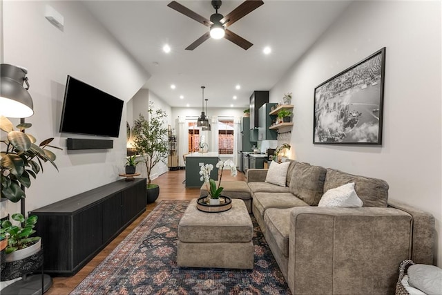 living room featuring hardwood / wood-style floors and ceiling fan