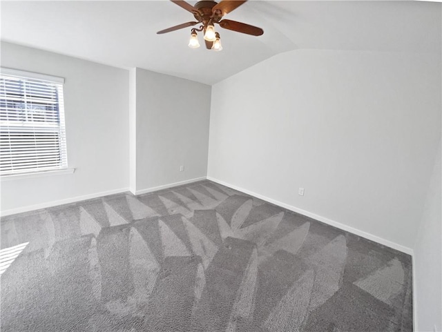 carpeted empty room featuring ceiling fan and vaulted ceiling