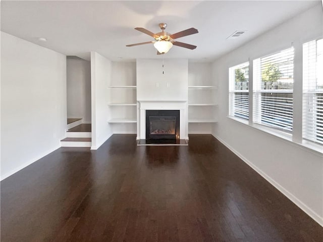 unfurnished living room with ceiling fan and dark hardwood / wood-style flooring