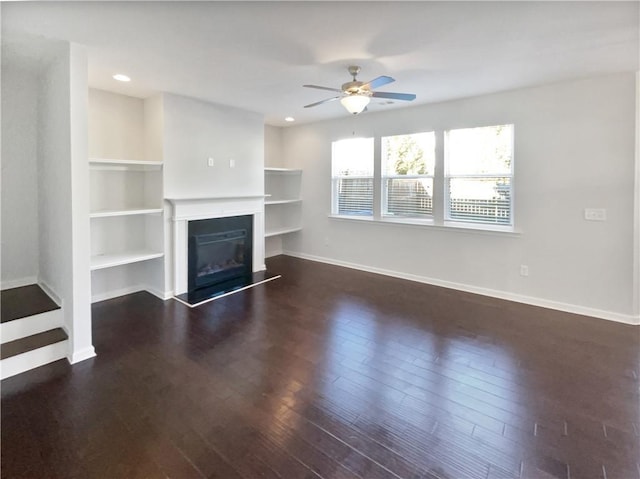 unfurnished living room featuring dark hardwood / wood-style floors and ceiling fan