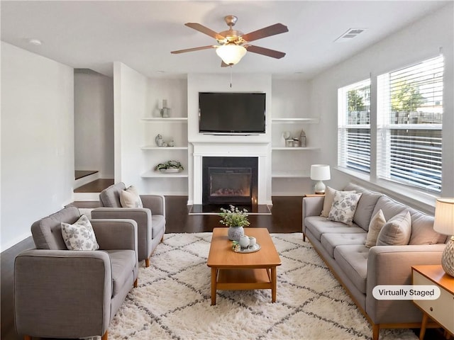 living room featuring light wood-type flooring and ceiling fan