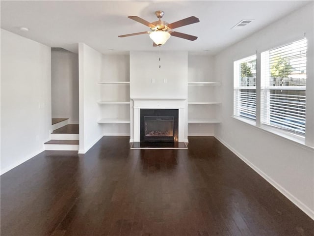 unfurnished living room with ceiling fan and dark hardwood / wood-style floors