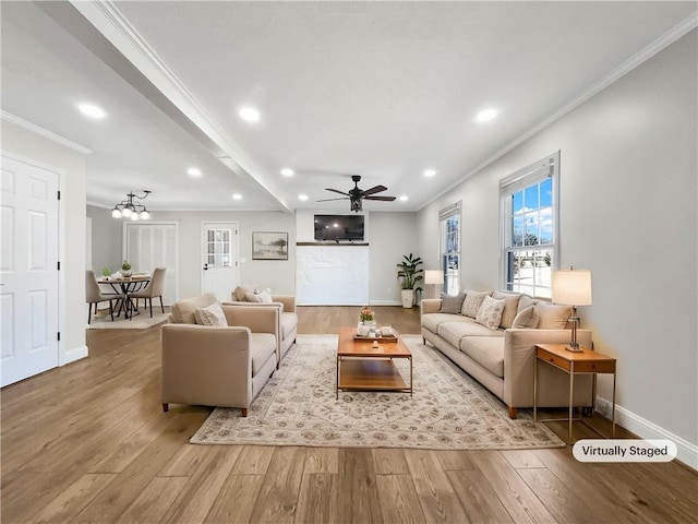 living room with baseboards, recessed lighting, wood finished floors, and crown molding