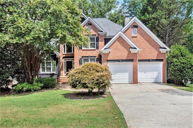 view of front of property with a front lawn and a garage