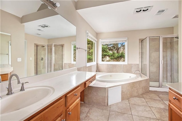 bathroom with tile patterned floors, vanity, and independent shower and bath