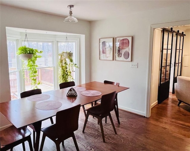 dining area with wood finished floors and baseboards