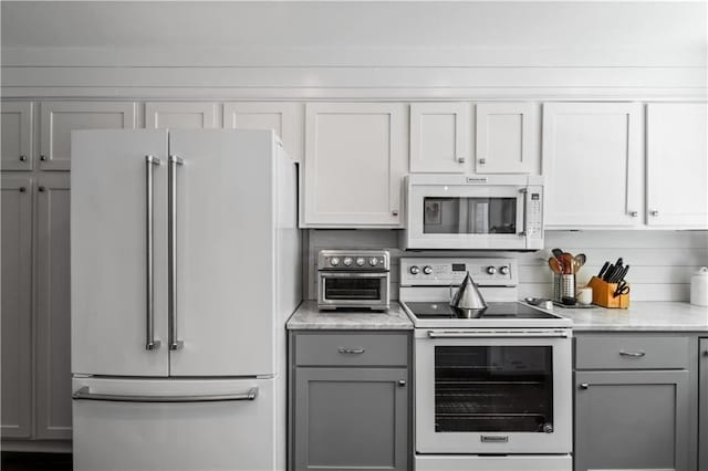 kitchen with white appliances and gray cabinets