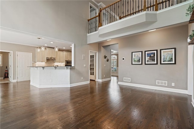 1758 Rosehedge Way NW, Kennesaw, GA 30152 - unfurnished living room featuring a towering ceiling, baseboards, and dark wood-style floors