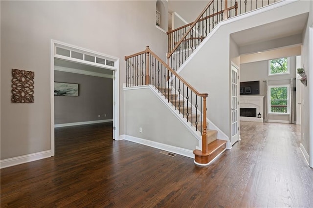 1758 Rosehedge Way NW, Kennesaw, GA 30152 - stairway with a high ceiling, wood finished floors, baseboards, and a fireplace