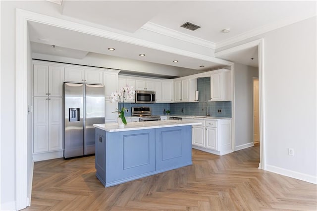 2161 Peachtree Rd NE Unit 907, Atlanta, GA 30309 - kitchen featuring appliances with stainless steel finishes, a sink, ornamental molding, white cabinets, and baseboards