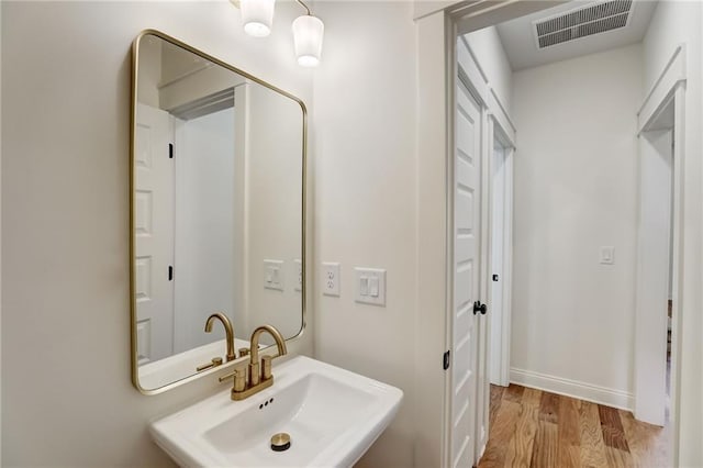 bathroom featuring hardwood / wood-style flooring and sink