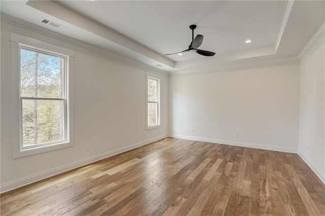 spare room featuring a wealth of natural light, light wood-type flooring, and ceiling fan