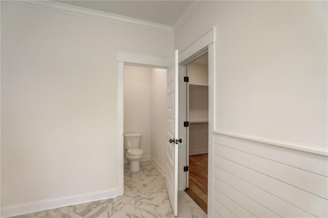 bathroom featuring toilet and ornamental molding