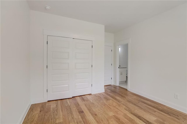 unfurnished bedroom with light hardwood / wood-style floors and a closet