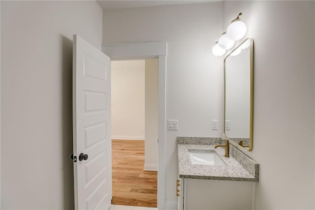 bathroom with vanity and wood-type flooring