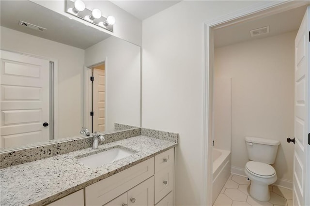 bathroom with vanity, toilet, and tile patterned floors