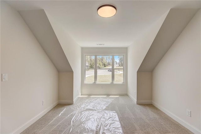 additional living space with light colored carpet