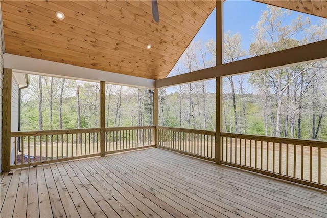 unfurnished sunroom featuring ceiling fan, wooden ceiling, and vaulted ceiling