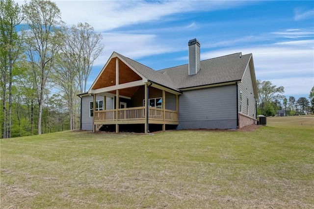 back of property featuring a yard, central AC, and a wooden deck