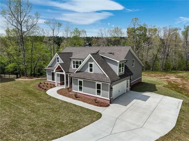 craftsman house with a front lawn and a garage